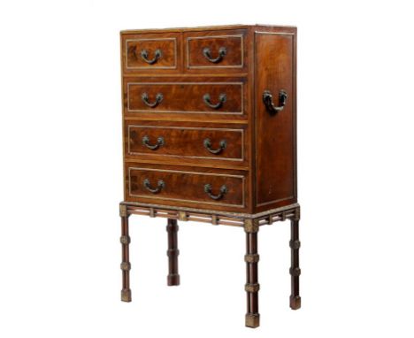 A 'Chippendale' revival mahogany and parcel gilt chest on stand, with two short and three long graduated drawers, with side c