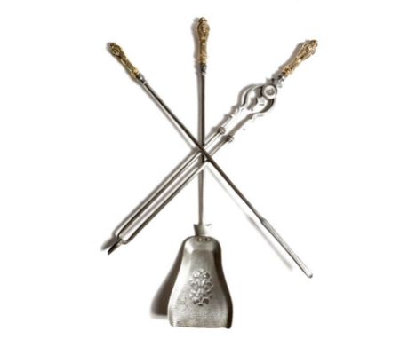 A set of three Victorian steel fire tools, each with a cartouche and mask gilt brass handle, with a pierced pan, 78.7cm long 