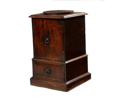 A George III mahogany pedestal urn cupboard, the top with a circular raised plinth, above a door enclosing a shelf, with a pu