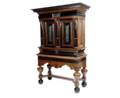 λ A Dutch rosewood and ebony Baroque cabinet on stand or luiermanskastje, with ripple mouldings, the detachable cornice with 