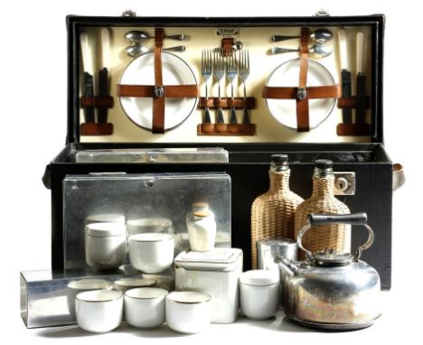 A 'Sirram' car picnic set for lunch and tea, fitted with plates, cutlery, whicker and glass bottles, a kettle and containers,