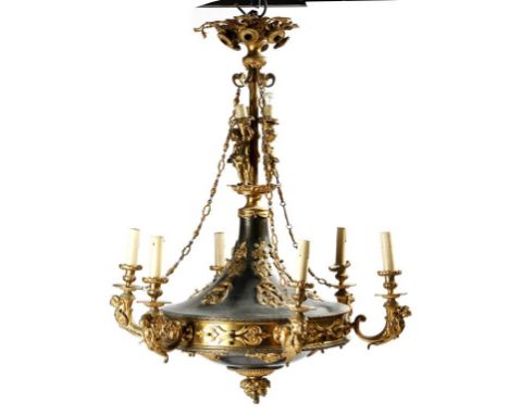 A French gilt and patinated brass fifteen light chandelier, the pierced corona above a stem decorated with cherubs holding to