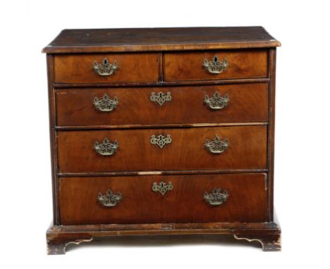 An early 18th century walnut chest, the quarter veneered top with cross and feather banding, above two short and two long dra