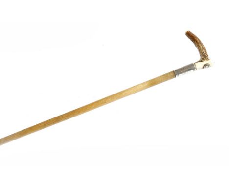 λ A late Victorian rhinoceros horn hunting whip by Swaine & Co., with an antler horn handle applied with a button inscribed '