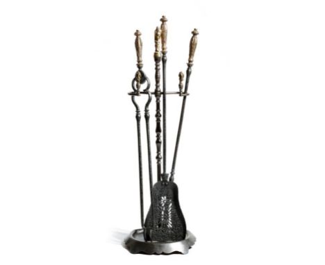 A set of three 19th century fire tools, each with a gilt brass handle decorated with leaves and beads, with a pierced pan, to
