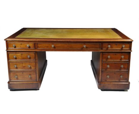 A mahogany twin pedestal partner's desk, the top inset with a gilt tooled green leather writing surface, fitted with an arran