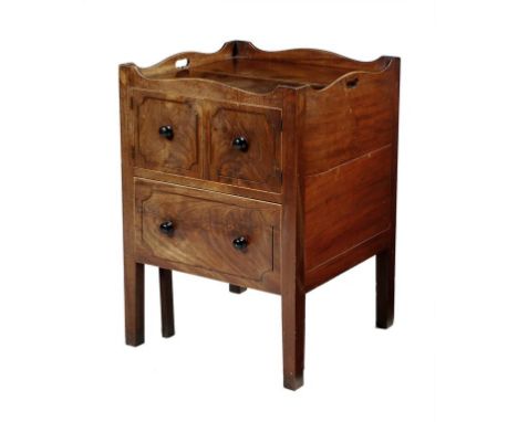 A George III mahogany tray-top commode, the shaped gallery pierced with two handgrips above a pair of cupboard doors and a pu
