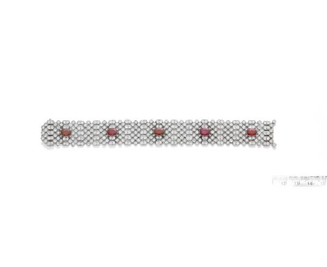A RUBY AND DIAMOND BRACELET, BY  CHARLES HOLL,  CIRCA 1925The oval-cut rubies on a flexible strap of honeycomb design, milleg