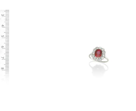 A RUBY AND DIAMOND CLUSTER RING, CIRCA 1915Set with a cushion-shaped ruby, weighing 2.49 carats, within a surround of old bri