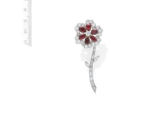 A RUBY AND DIAMOND FLOWER BROOCH,  BY VAN CLEEF AND ARPELS, CIRCA 1960Designed as a single bloom, the vari-cut diamond stem i