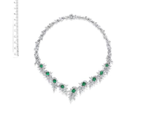 AN EMERALD AND DIAMOND NECKLACE, BY GÜBELIN, CIRCA 1965The highly articulated collar of foliate design, set to the front with