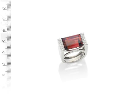 A TOURMALINE AND DIAMOND DRESS RING,  BY THEO FENNELL,  2004The large step-cut purplish-red tourmaline, between brilliant-cut