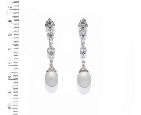 A PAIR OF NATURAL PEARL AND DIAMOND EARRINGS, CIRCA 1920Each natural pearl drop suspended from an articulating series of bull