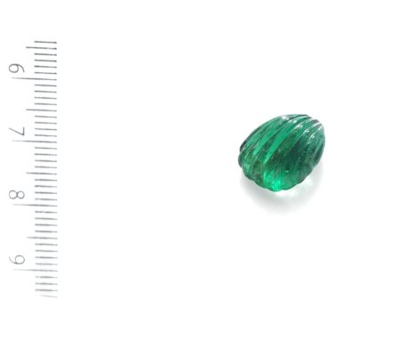 AN UNMOUNTED EMERALDThe drilled emerald bead, probably Mughal, weighing 9.28 carats, fluted on each sideFootnotes:Accompanied