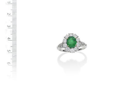 AN EMERALD AND DIAMOND RING, BY  VAN CLEEF AND ARPELSThe oval-cut emerald within a brilliant-cut diamond surround, the should