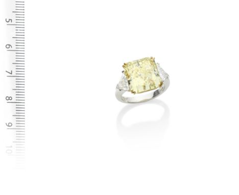 A FANCY-COLOURED DIAMOND AND DIAMOND RINGThe radiant-cut Fancy Intense Yellow diamond, weighing 10.11 carats, between shoulde
