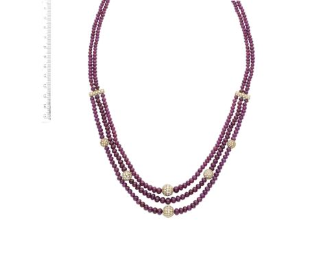 A RUBY BEAD AND DIAMOND NECKLACESet to the front with three tiered strands of ruby beads, accented at intervals with baton-sh