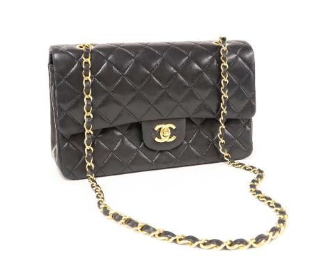 A Chanel black leather medium flap bag,gold tone hardware, chain and leather strap, CC front closure, interior with slip pock