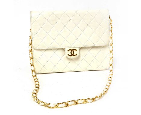 A Chanel vintage cream single flap bag, gold tone hardware with CC front stud closure, interior with zip pocket, with serial 