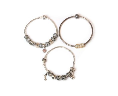 Two Pandora charm bracelets,11 charms, 212mm long, 8 charms, 212mm long, together with a Pandora engraved charm bangle,machin