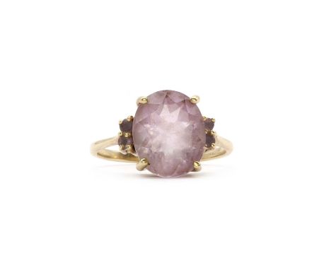 A 9ct gold amethyst ring, an oval mixed cut amethyst, 9mm x 12mm, claw set to the centre, with mixed cut amethyst claw set to