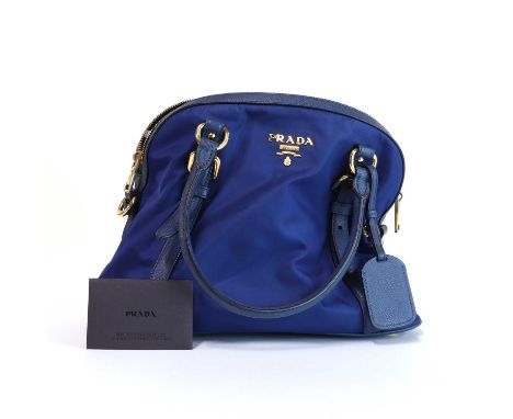 A Prada Bauletto Tessuto Saffiano nylon bag,with blue leather dual rolled handles, detailing and trim, gold tone hardware, th