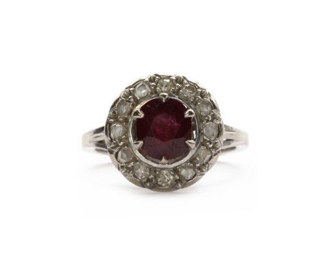 A white gold ruby and diamond cluster ring,a round mixed cut ruby, claw set, to a surround of rose and eight cut diamonds, gr