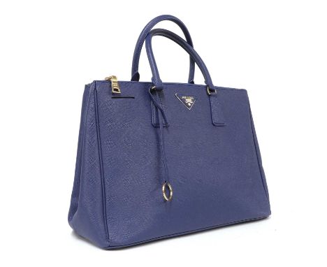 A Prada royal blue Saffiano bag,gold tone hardware, dual rolled handles, two section zip top closure with interior zip and sl