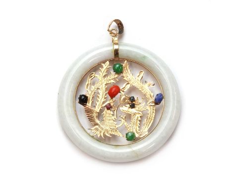 An open circle jade pendant,the circular piece, 54mm in diameter, with a gold gem set dragon applied to the centre of a jade 