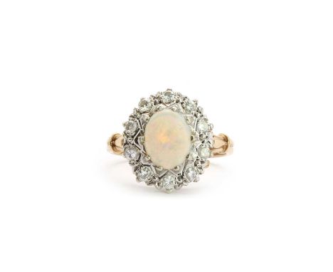 A 9ct white gold opal and diamond cluster ring,with an oval cabochon opal, 6.5mm x 8.8mm, claw set to the centre, a surround 