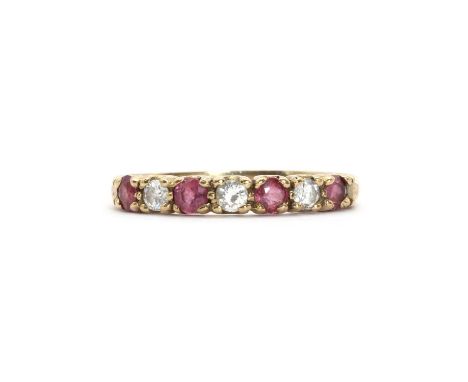 A 9ct gold ruby and diamond half eternity ring,a row of alternating circular cut rubies and round brilliant diamonds, claw se