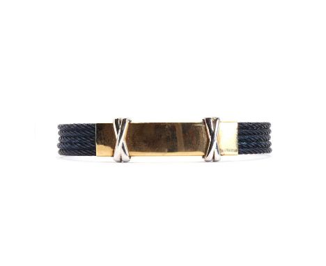 A two colour gold cable bangle,10mm wide, with four rows of twisted navy colour cable, accented by a two-colour gold centre s