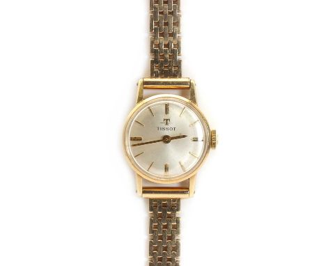 A ladies' gold Tissot mechanical bracelet watch,a round silver dial, 18mm diameter, raised gold plated batons and hour marker