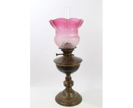 Edwardian brass oil lamp with acid-etched cranberry glass shade, 60cm high