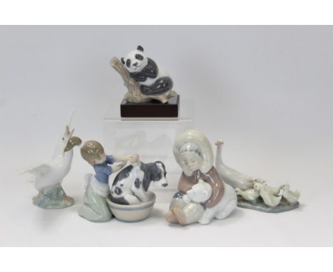 Three Lladro porcelain figures - Eskimo with polar bear cub, girl washing a dog, panda on plinth base, plus two Lladro geese