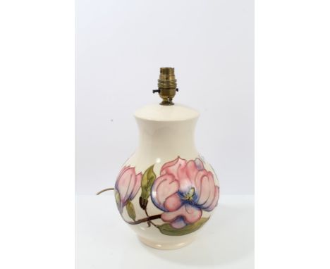 Moorcroft pottery table lamp decorated in the Magnolia pattern on cream ground, with shade