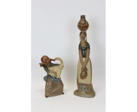 Two Lladro Gres figures - girl holding a swan and woman carrying a water jug on her head