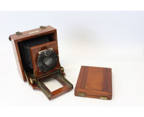 A Lancaster mahogany and brass plate camera fitted with a Lompro Doppel Anastigmat lens of 135mm focal length by Romain Talbo