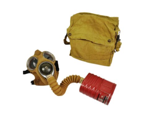 An original WWII Second World War British Army issued Service Respirator / Gas Mask. Fabric lined rubber mask with glass eye 