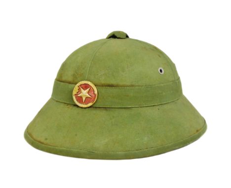 A vintage Vietnam War era NVA North Vietnamese Army fibre pith helmet. Fiber mould with khaki cloth and front NVA star badge.