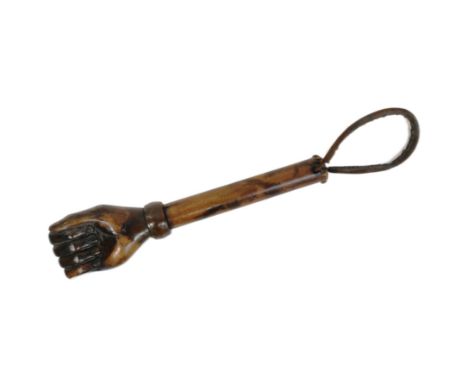 A vintage hardwood truncheon with the pommel carved in the form of a fist. The shaft with a leather carry loop. Measures appr