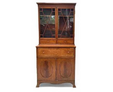 A late 19th century Satinwood secretaire bookcase. The upper section with twin astragal glazed doors over two short drawers t