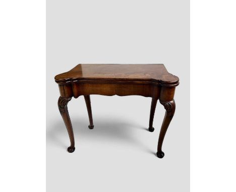 A George II card table The shaped top opening onto baize, the concave front with a single drawer, the cabriole legs with acan