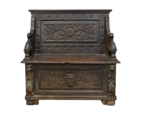 A late Victorian oak carved hall bench. With under seat storage, height 92cm width 93cm depth 45cm.