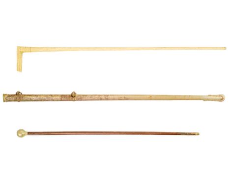 A marine bone walking cane. Length 81cm together with a Devonshire Regiment swagger stick and an Officer sword scabbard. (3)