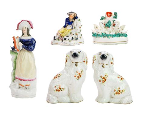 Five various Staffordshire figures. Including a pair of spaniels, height 15cm, a swan spill vase group, a sleeping Scotsman g
