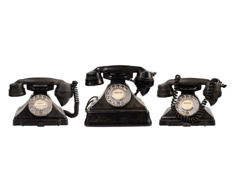 Three vintage black Bakelite telephones. A GPO 162F example, another, with a drawer marked FWR 65/2 1/232 L, and another simi