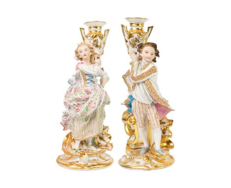 A pair of French porcelain candlestick figures. Circa 1880, fashioned as a beau, in 18th century costume, and his female comp
