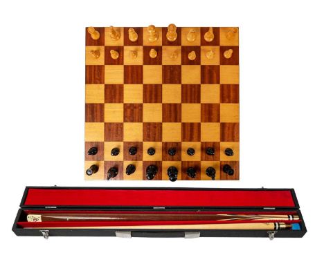 A boxwood and ebony weighted chess set. Height of king 9cm with a chess board, and a Sams Atlas Northampton cue.General wear 