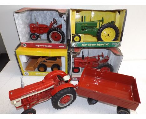 ERTL:- three Die-cast tractors and an Earthmover, each boxed, together with a similar tractor with a tinplate trailer.